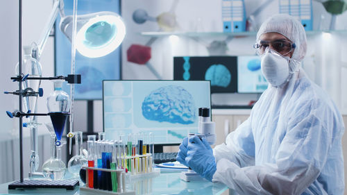 Rear view of female scientist working in laboratory