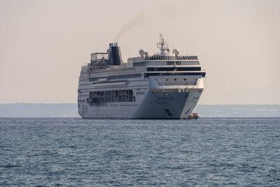 Ship sailing on sea against clear sky