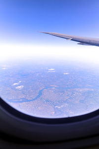 Aerial view of sky seen through airplane window