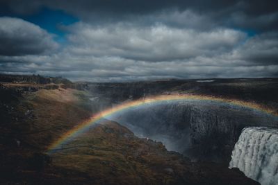 Scenic view of rainbow over rock formation