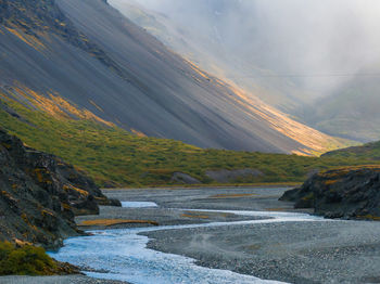 Scenic view of sea and mountains against sky