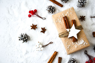 Zero waste christmas presents with decorations on white snow background. copy space. eco friendly