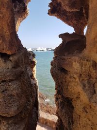 Close-up of rock formation by sea against sky