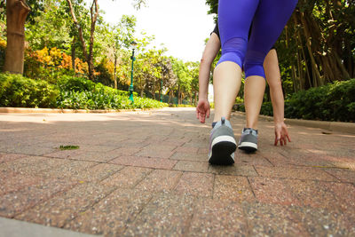 Low section of woman on footpath