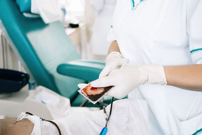 Midsection of doctor examining patient in hospital