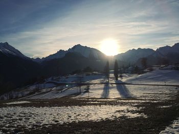 Scenic view of snowcapped mountains against sky during sunset