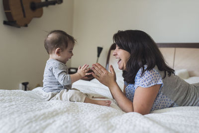 Mother and daughter on bed