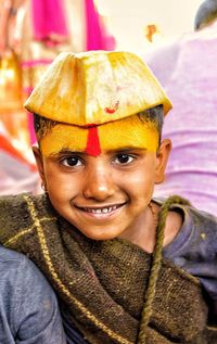 Close-up portrait of smiling boy with face paint