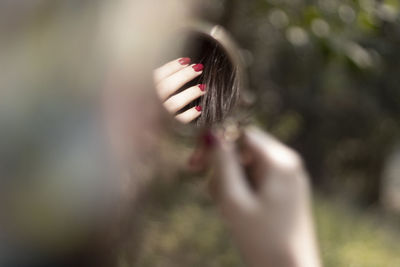 Close-up of woman hand holding plant