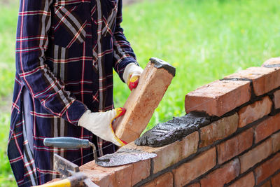 Man working on brick wall