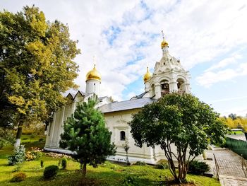 View of trees and building against sky