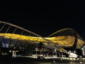 Low angle view of illuminated bridge against sky at night