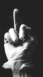 Close-up of human hand against black background