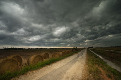 Scenic view of agricultural field against storm clouds