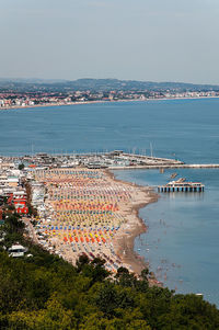 High angle view of sea and buildings against sky