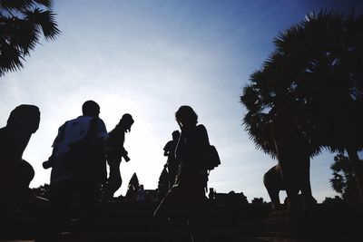 Low angle view of silhouette people against sky