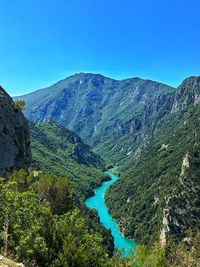 Scenic view of mountains against clear blue sky