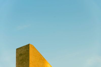 Low angle view of built structure against blue sky