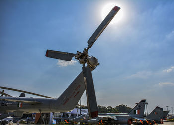 Low angle view of crane against sky