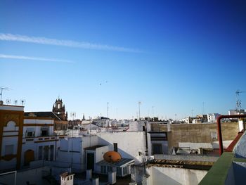 Buildings in city against blue sky