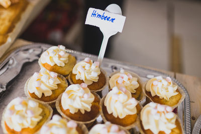 High angle view of cupcakes in tray for sale