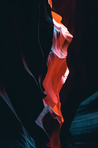 Low section of multi colored fire against black background