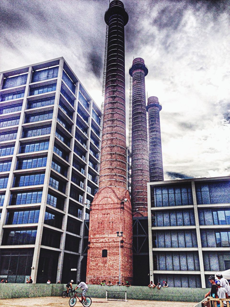 building exterior, architecture, built structure, low angle view, sky, city, building, cloud - sky, window, day, outdoors, tall - high, city life, street light, office building, street, cloud, residential building, cloudy