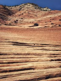 Scenic view of desert land against sky