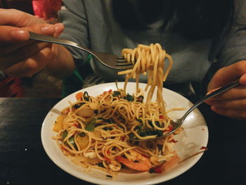 Close-up of man eating food pasta