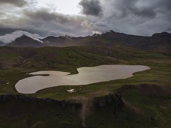 Scenic view of lake and mountains against sky