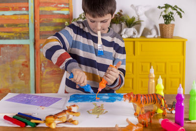 Boy creating artwork at home.