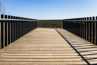 Wooden platform with steel handrails and love padlocks hanging on it