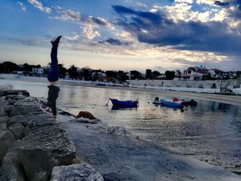 People on beach against sky