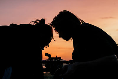 Silhouette of people at sunset