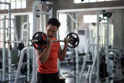 Young man exercising in gym