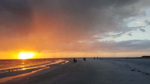 Scenic view of beach against sky during sunset