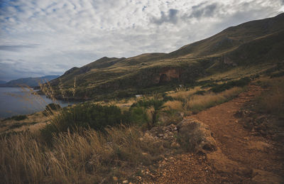 Scenic view of mountains against cloudy sky