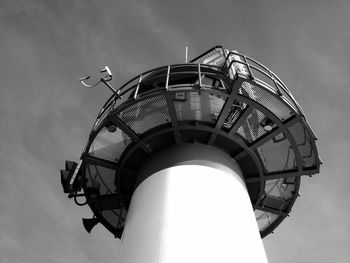 Low angle view of modern lighthouse against sky