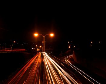 High angle view of light trails on highway at night