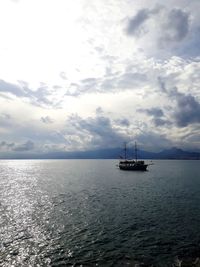 Ship sailing on sea against sky