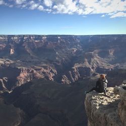 High angle view of woman sitting on cliff at grand canyon national park