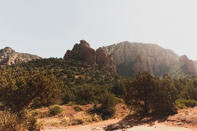 Rock formations on landscape against clear sky