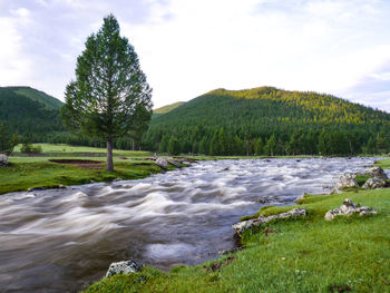 Scenic view of waterfall against sky