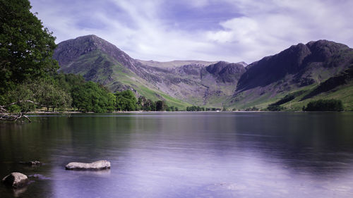 Scenic view of lake and mountains against sky