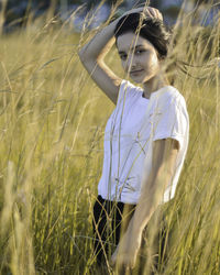Young woman standing in wheat field