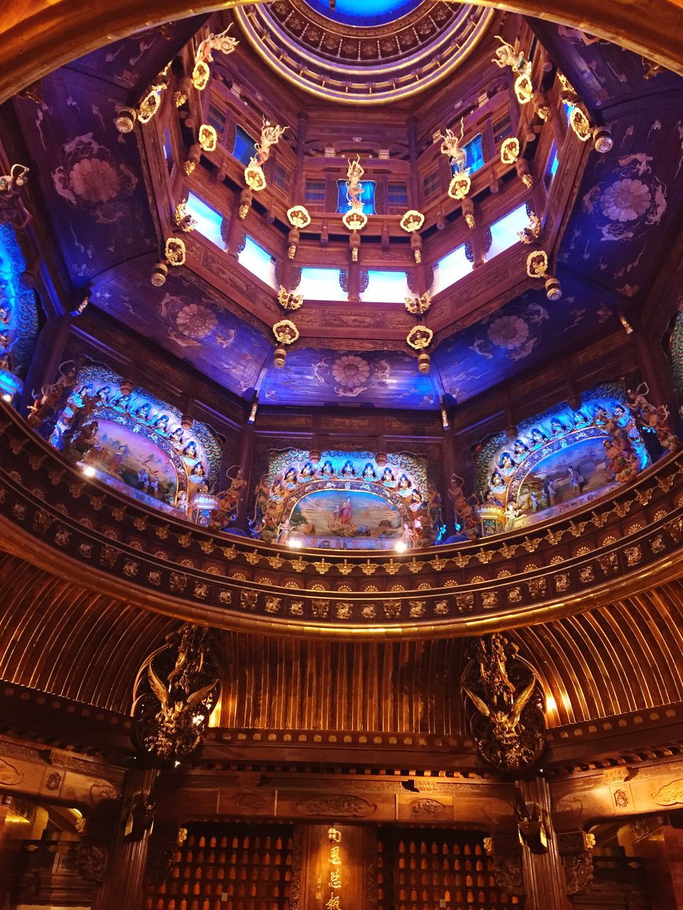 indoors, place of worship, low angle view, ceiling, religion, ornate, architecture, spirituality, design, built structure, church, pattern, architectural feature, chandelier, illuminated, famous place, temple - building, stained glass, decoration