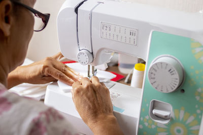 Close-up of woman working on sewing machine