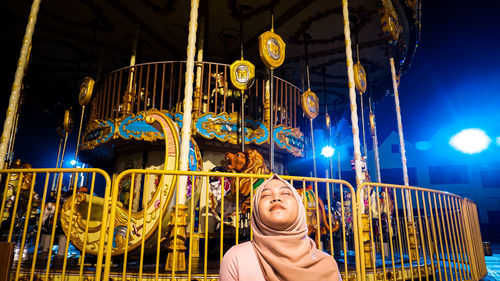 Portrait of smiling young woman at amusement park