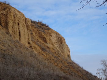 Low angle view of rock formations against sky