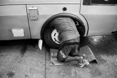 Low section of man repairing car